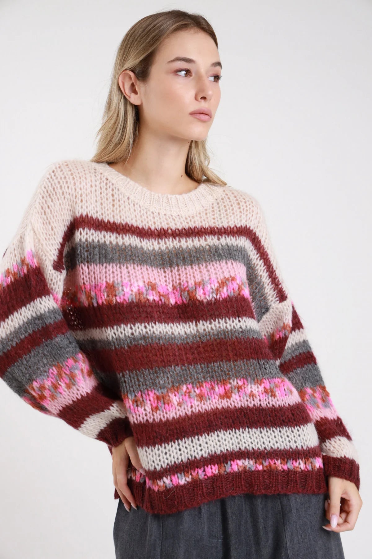 Maglione mohair righe panna bordeaux grigio girocollo oversize jacquard - modella busto frontale tre quarti braccia ai fianchi sguardo laterale pantaloni grigi capelli biondi