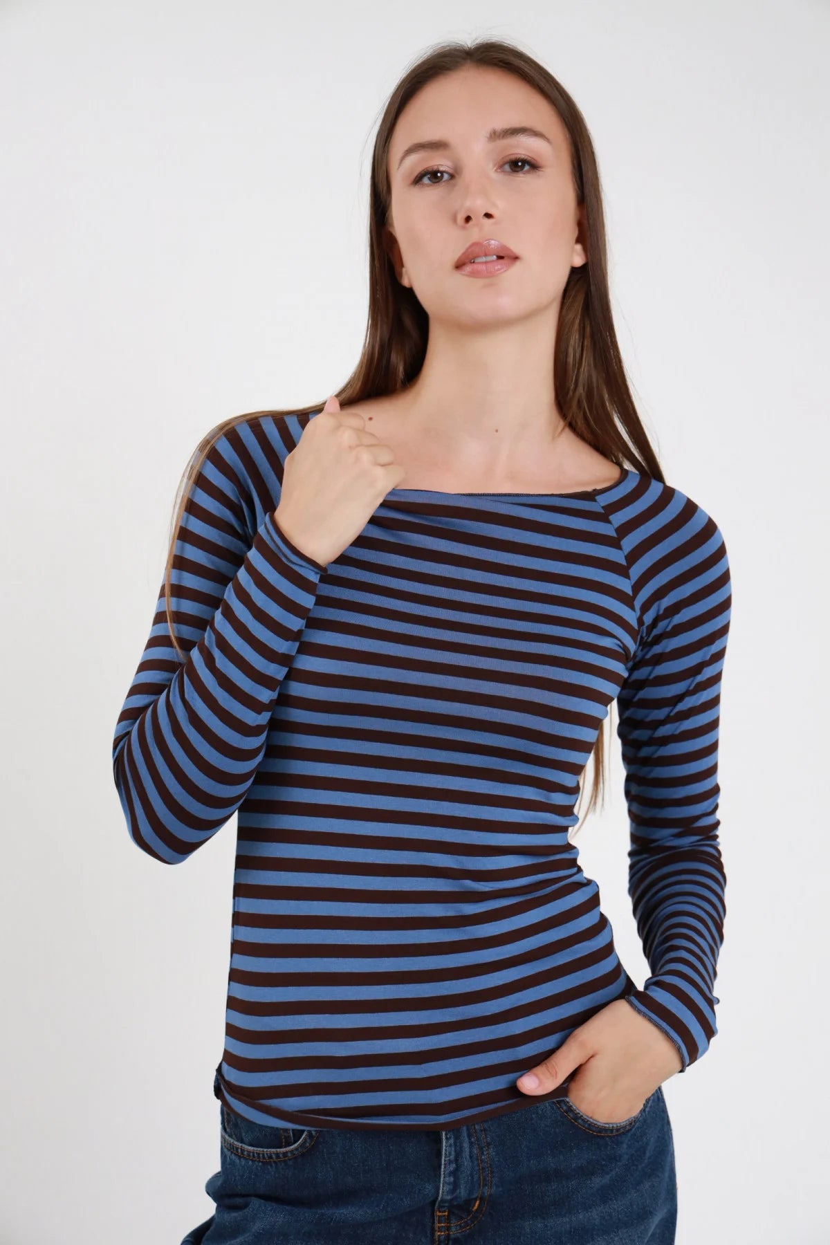 T-shirt barchetta righe azzurro marrone scuro donna maniche lunghe aderente collo barchetta ampio - vista frontale mano al collo con jeans blu