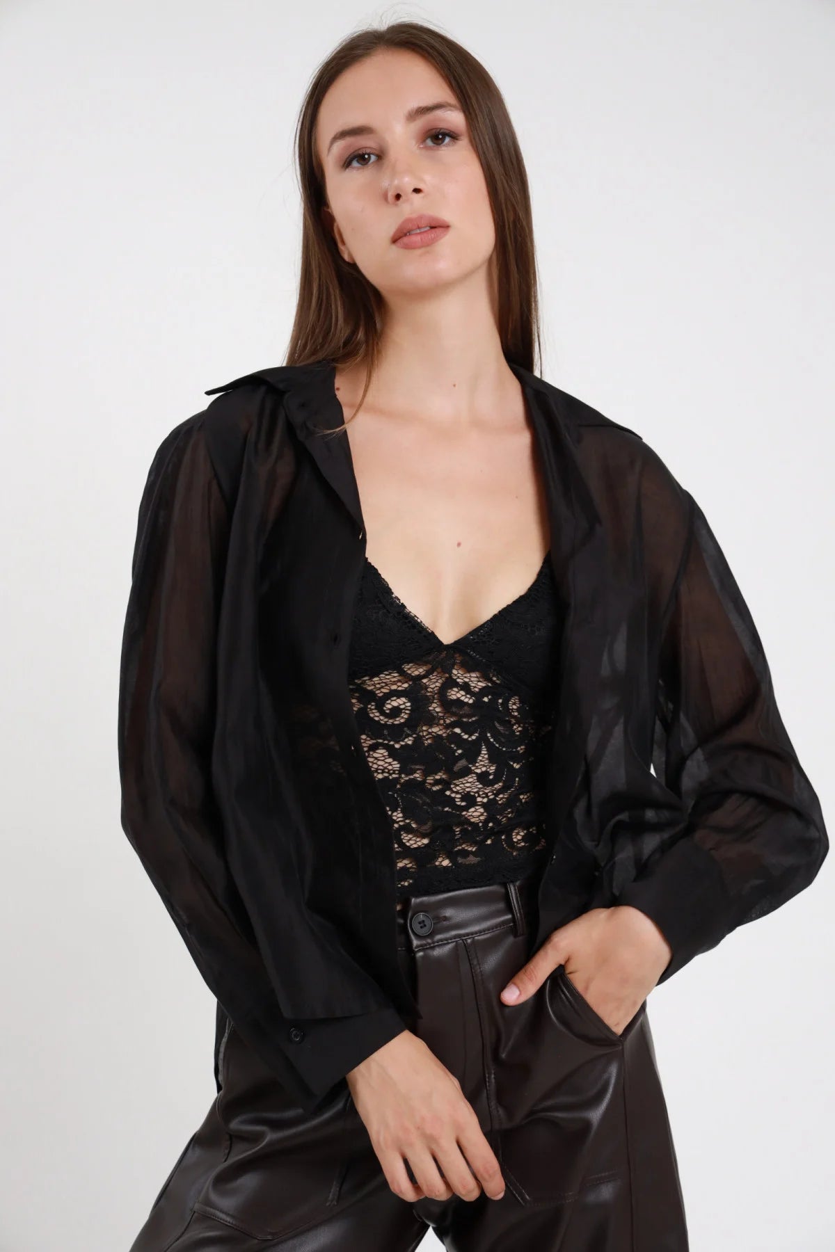 Coordinato camicia chiffon nera semitrasparente e top in pizzo nero abbinati a pantaloni in pelle neri - vista frontale