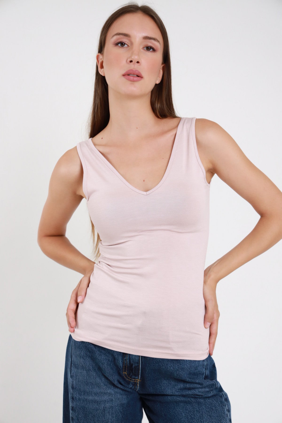 Canotta scollo V rosa cipria donna bretelle larghe aderente - vista frontale con jeans blu