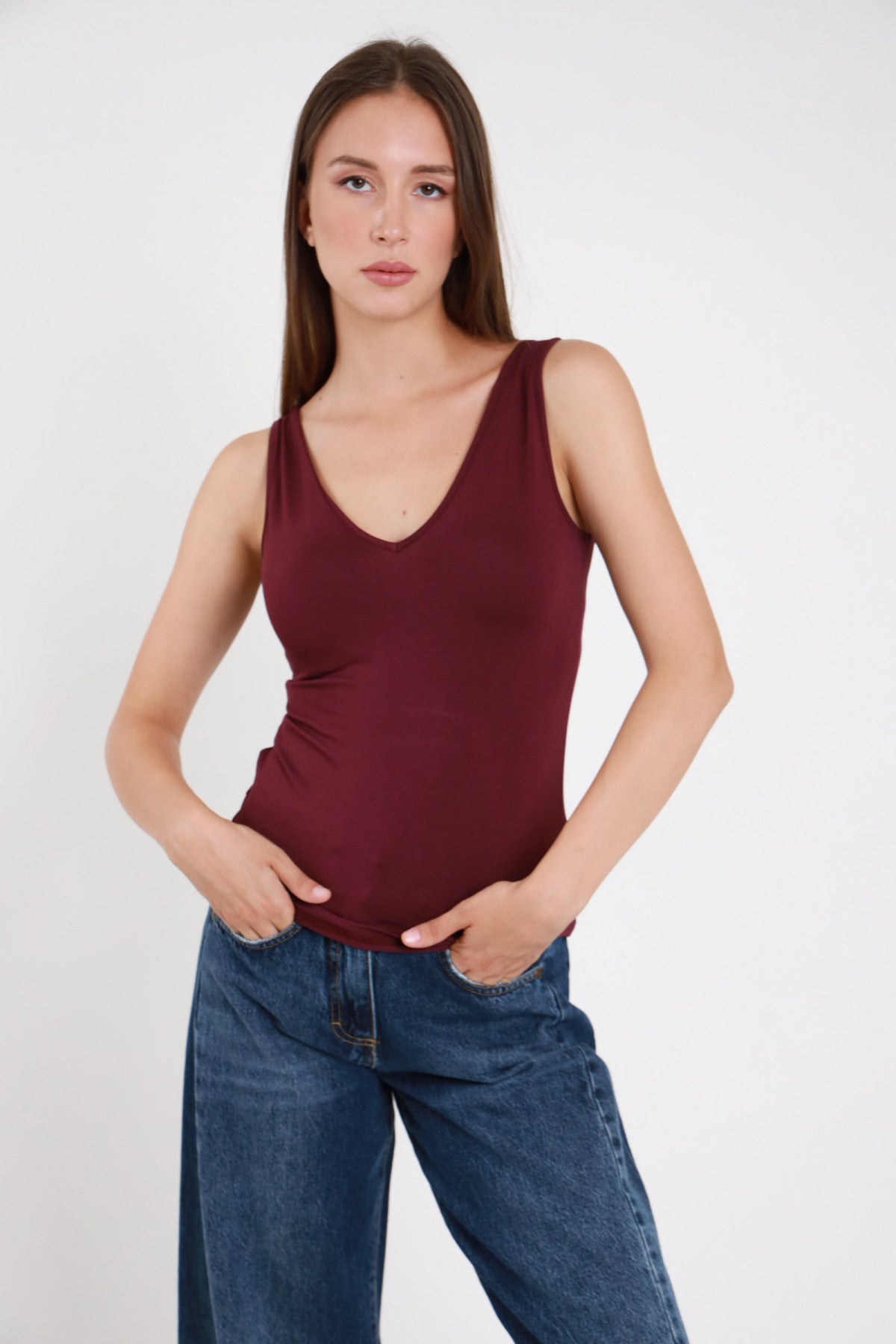 Canotta scollo V bordeaux donna bretelle larghe aderente - vista frontale con jeans blu