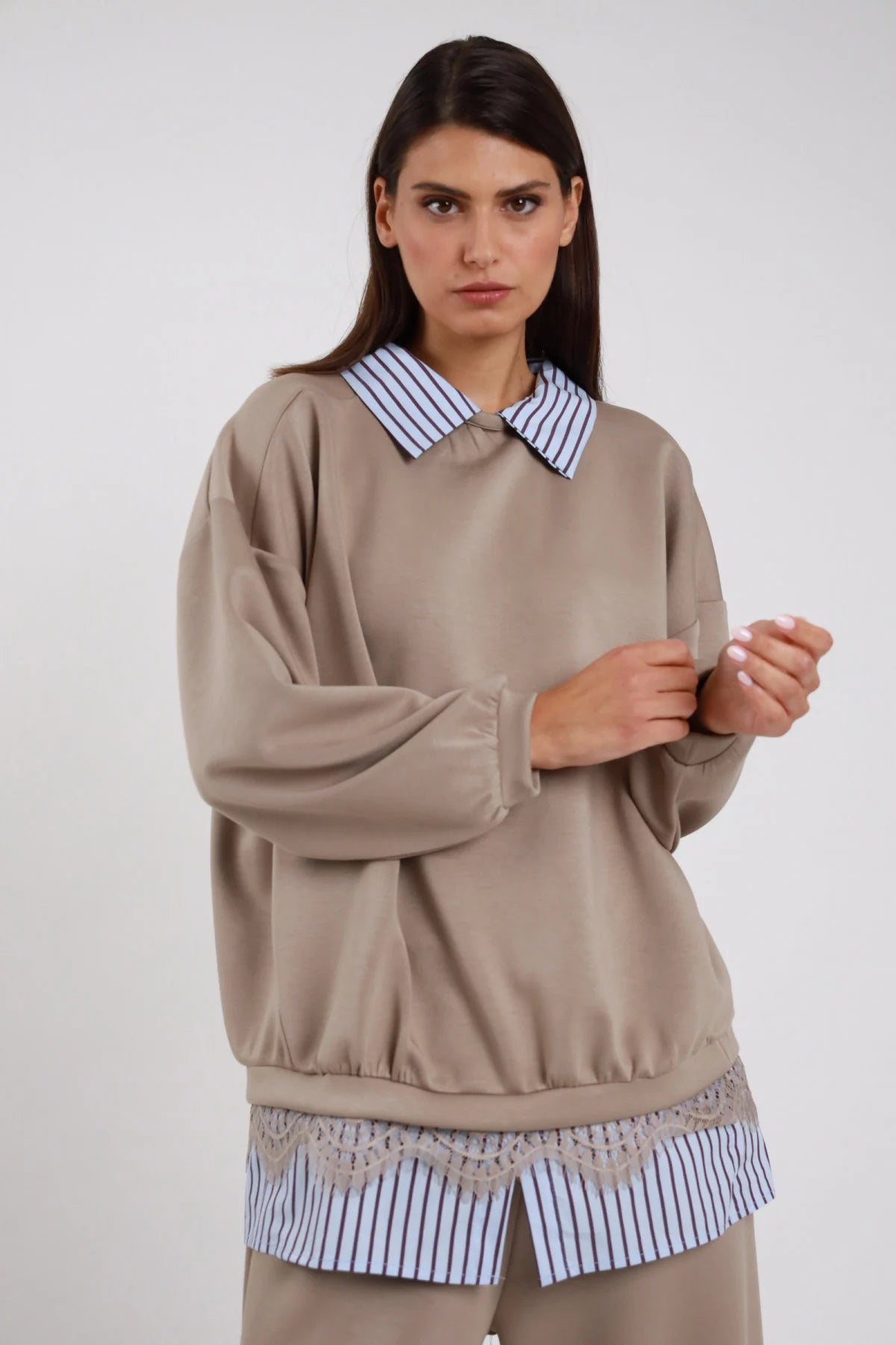 Felpa Girocollo Oversize Camicia Righe Pizzo tortora beige caldo 48% rayon colletto camicia righe blu bianco girocollo orlo camicia pizzo smerlato ricamato floreale beige panna elastico fondo manica raglan ampia silhouette boxy - modella busto frontale mani intrecciate sguardo frontale intenso capelli castani lisci sfondo bianco pantaloni tortora coordinati