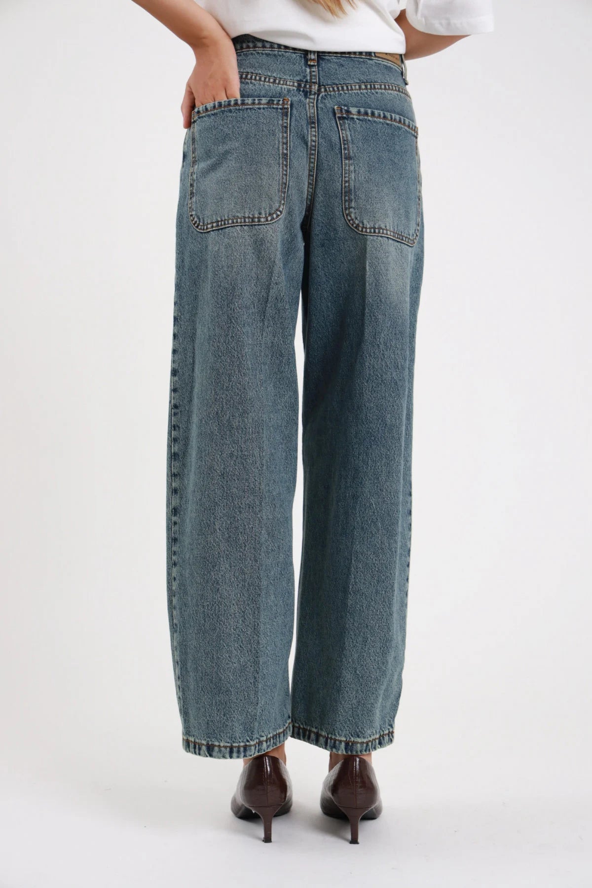 Jeans wide leg ultra-ampio vita alta denim vintage - modella vista posteriore intera dettaglio tasche posteriori e orlo grezzo con décolleté marroni