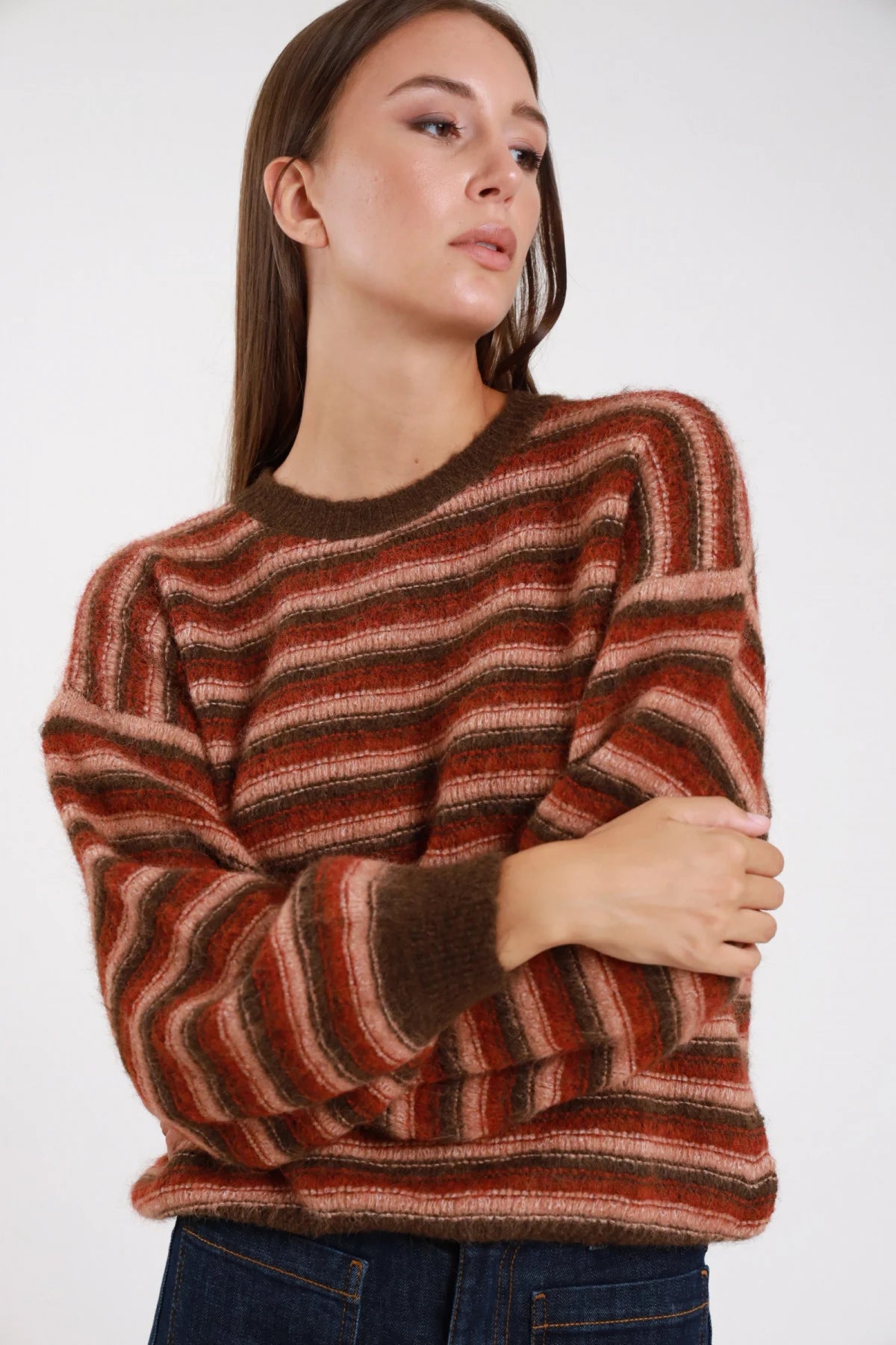 Maglione righe multicolor wave ruggine cotto khaki frontale busto braccia conserte girocollo costina manica ampia - modella frontale busto braccia conserte sguardo laterale alto jeans indaco capelli castani lisci