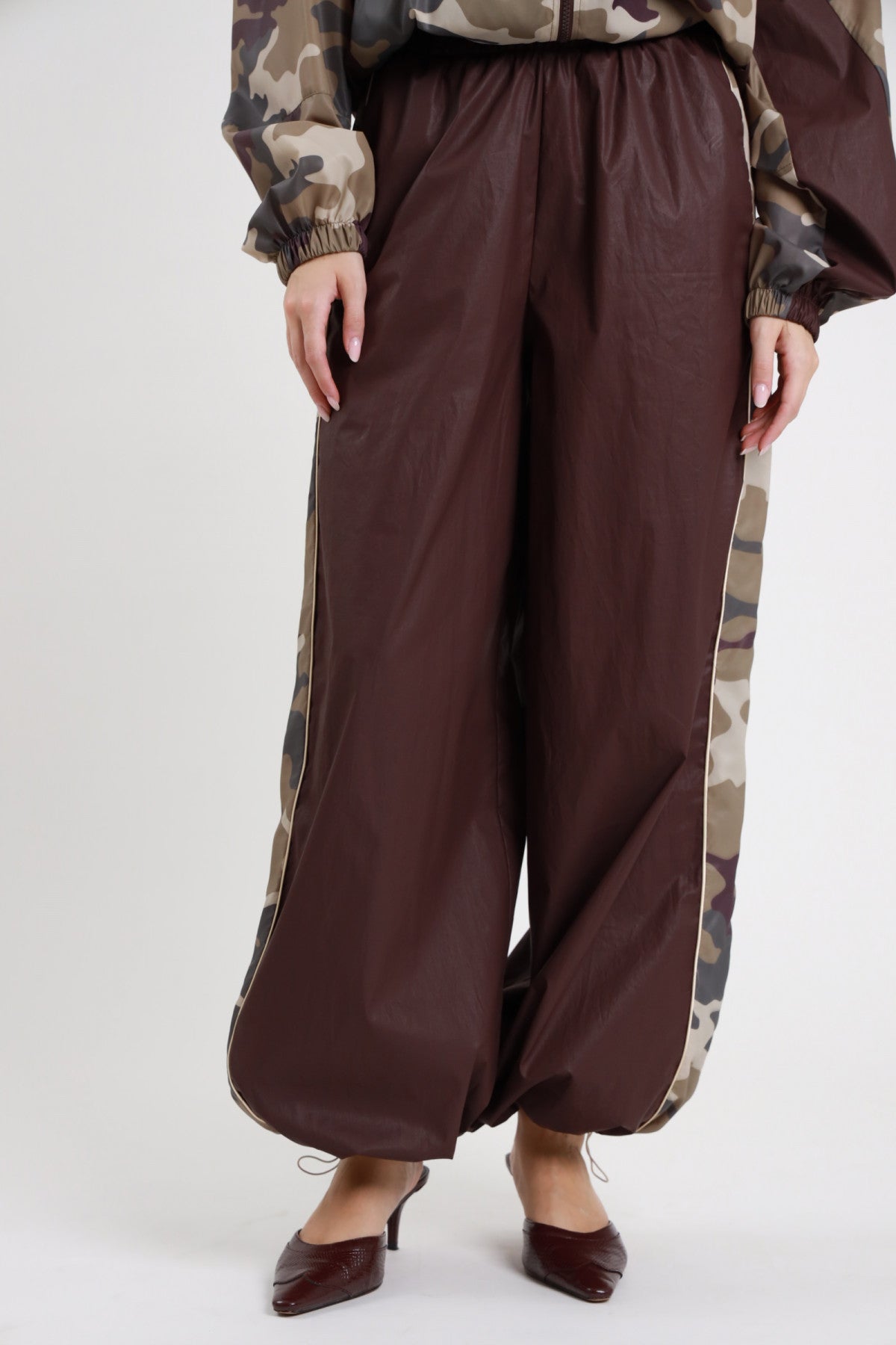 Pantalone Banda Camouflage cioccolato bordeaux 100% nylon vita elastica alta tasche laterali filo banda camouflage marrone verde khaki profilo beige panna gamba palazzo fluida fondo balloon dettaglio vita gamba frontale - modella vita gamba frontale mani tasche sfondo bianco bomber over mimetico camouflage abbinato sabot croco bordeaux